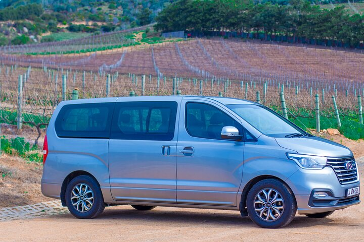 Experience seamless airport transfers with a backdrop of scenic vineyards ensuring you arrive in style while navigating the bustling roads of Cape Town effortlessly.